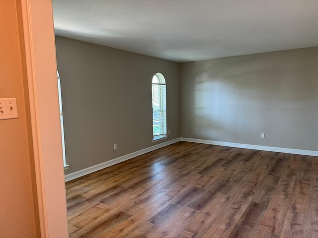 7750 Dentcrest Dr, Dallas, TX 75254 - empty room featuring dark wood-type flooring and baseboards