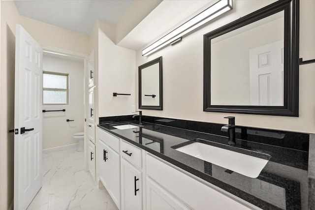 902 Mission Dr, Southlake, TX 76092 - bathroom with marble look tiles, double vanity, toilet, and baseboards