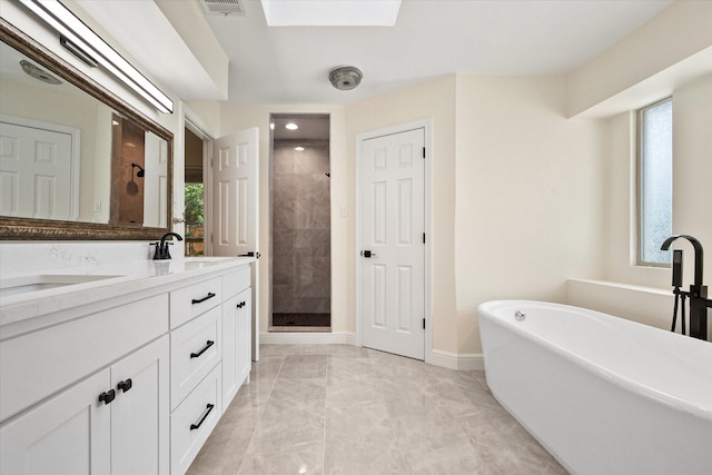 902 Mission Dr, Southlake, TX 76092 - full bath with a soaking tub, a shower stall, double vanity, marble finish floors, and a skylight