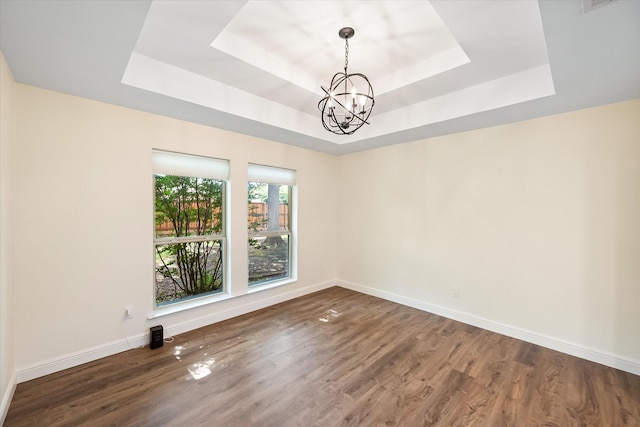 902 Mission Dr, Southlake, TX 76092 - empty room featuring a raised ceiling, a chandelier, wood finished floors, and baseboards