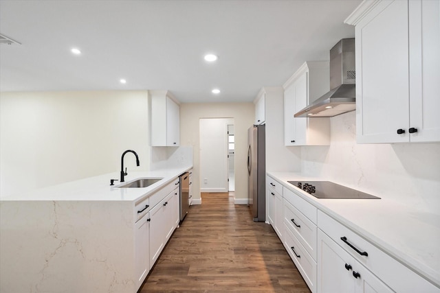 902 Mission Dr, Southlake, TX 76092 - kitchen with appliances with stainless steel finishes, wall chimney range hood, a sink, wood finished floors, and white cabinetry