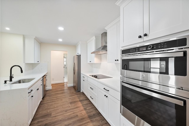 902 Mission Dr, Southlake, TX 76092 - kitchen featuring a sink, wall chimney exhaust hood, appliances with stainless steel finishes, light countertops, and wood finished floors