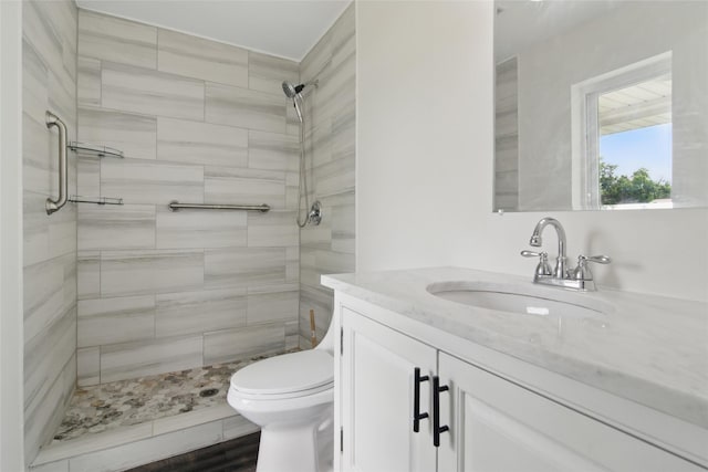 1025 Briar Way, Garland, TX 75043 - bathroom with vanity, tiled shower, and toilet