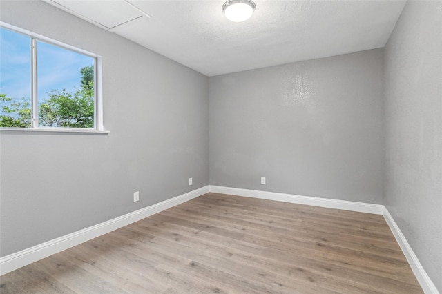 1025 Briar Way, Garland, TX 75043 - spare room with light wood finished floors and baseboards