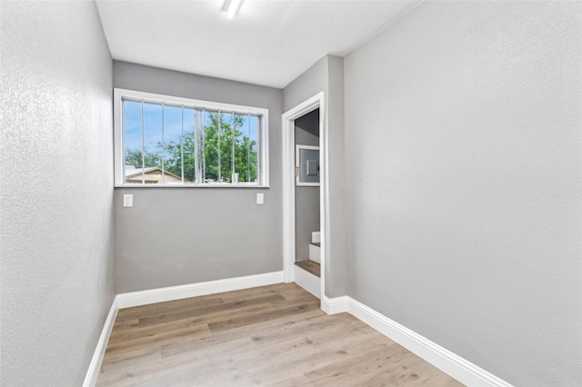 1025 Briar Way, Garland, TX 75043 - unfurnished room featuring wood finished floors and baseboards