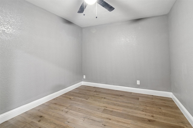 1025 Briar Way, Garland, TX 75043 - unfurnished room with wood finished floors, baseboards, and ceiling fan