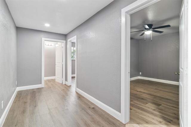 1025 Briar Way, Garland, TX 75043 - corridor featuring wood finished floors, baseboards, and a textured wall