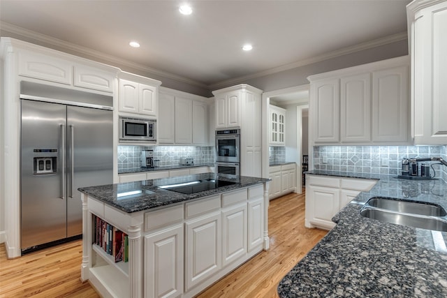 3217 Rankin St, University Park, TX 75205 - kitchen with built in appliances, a sink, a center island, white cabinets, and light wood-type flooring