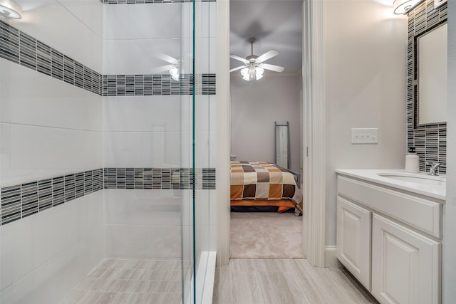 3217 Rankin St, University Park, TX 75205 - ensuite bathroom with vanity, tiled shower, ceiling fan, and wood finished floors