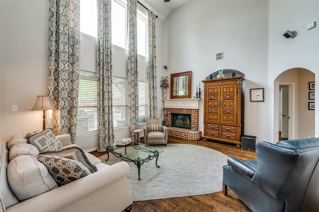 2362 Barret Dr, Frisco, TX 75033 - living room featuring a towering ceiling, arched walkways, plenty of natural light, and dark wood-style floors