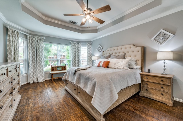 2362 Barret Dr, Frisco, TX 75033 - bedroom featuring a tray ceiling, crown molding, dark wood-style flooring, ceiling fan, and baseboards