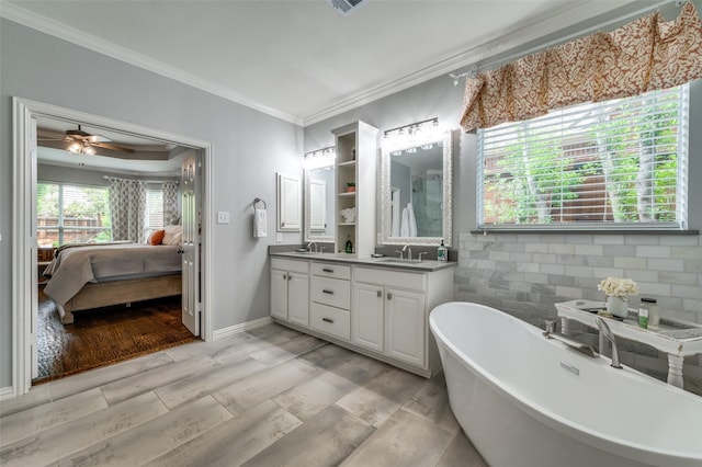 2362 Barret Dr, Frisco, TX 75033 - full bath with ensuite bathroom, crown molding, double vanity, a soaking tub, and a ceiling fan