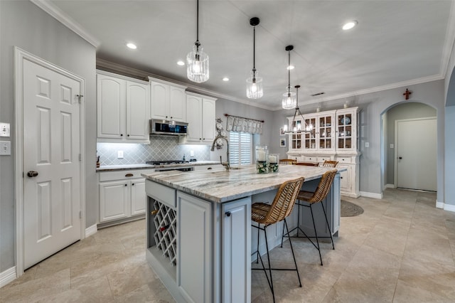 2362 Barret Dr, Frisco, TX 75033 - kitchen with crown molding, white cabinetry, arched walkways, glass insert cabinets, and stainless steel microwave