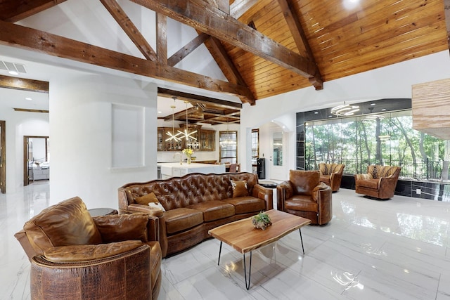5720 County Road 1094, Celeste, TX 75423 - living room with a chandelier, wood ceiling with exposed beams, arched walkways, high vaulted ceiling, and marble finish flooring