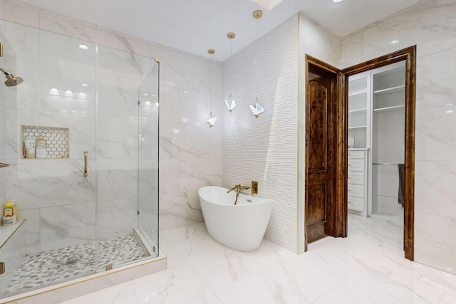 5720 County Road 1094, Celeste, TX 75423 - bathroom with a marble finish shower, a freestanding bath, marble tiled floors, and tile walls