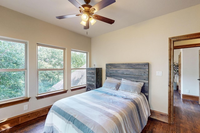 5720 County Road 1094, Celeste, TX 75423 - bedroom featuring dark wood finished floors, baseboards, and ceiling fan