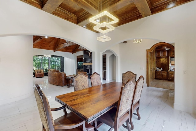5720 County Road 1094, Celeste, TX 75423 - dining space with wooden ceiling with exposed beams, arched walkways, a chandelier, light marble finish flooring, and coffered ceiling