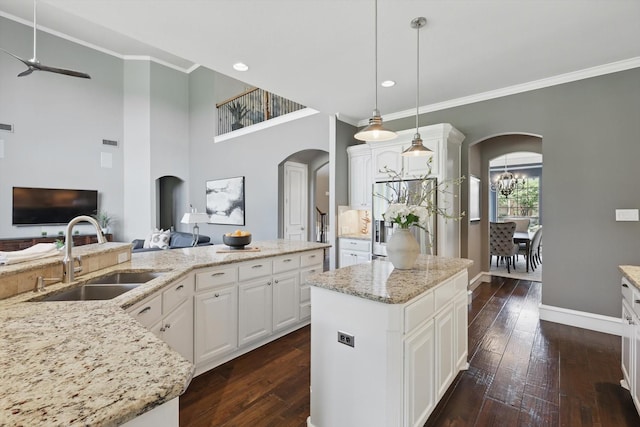702 Malton Ln, Southlake, TX 76092 - kitchen with a sink, arched walkways, ceiling fan, ornamental molding, and stainless steel fridge with ice dispenser