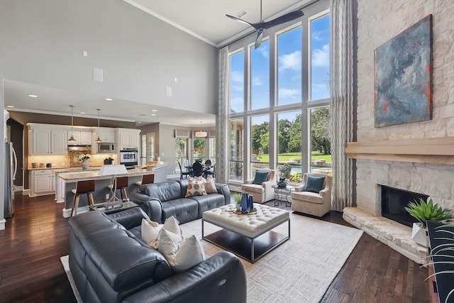 702 Malton Ln, Southlake, TX 76092 - living room featuring high vaulted ceiling, ornamental molding, dark wood-style flooring, and a fireplace