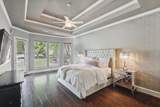 702 Malton Ln, Southlake, TX 76092 - bedroom featuring a tray ceiling, baseboards, wood finished floors, wallpapered walls, and crown molding