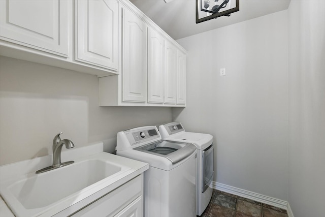 702 Malton Ln, Southlake, TX 76092 - laundry area featuring independent washer and dryer, cabinet space, baseboards, and dark stone finish floors