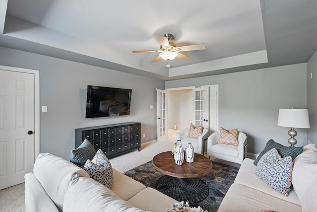 702 Malton Ln, Southlake, TX 76092 - carpeted living room featuring a tray ceiling, ceiling fan, baseboards, and french doors