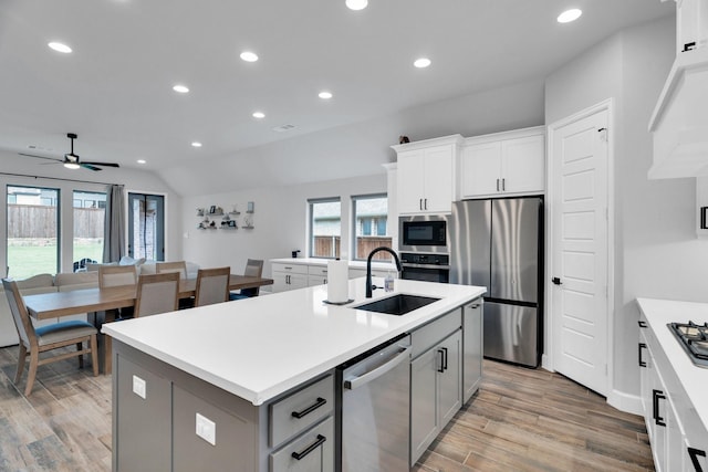 1210 Old Rocksprings Pass, Mansfield, TX 76063 - kitchen featuring stainless steel appliances, a sink, gray cabinets, light wood finished floors, and recessed lighting