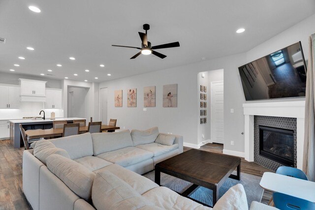 1210 Old Rocksprings Pass, Mansfield, TX 76063 - living area featuring wood finished floors, a ceiling fan, recessed lighting, a tile fireplace, and baseboards