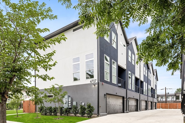 4707 Virginia Ave Unit 103, Dallas, TX 75204 - view of property featuring an attached garage and driveway