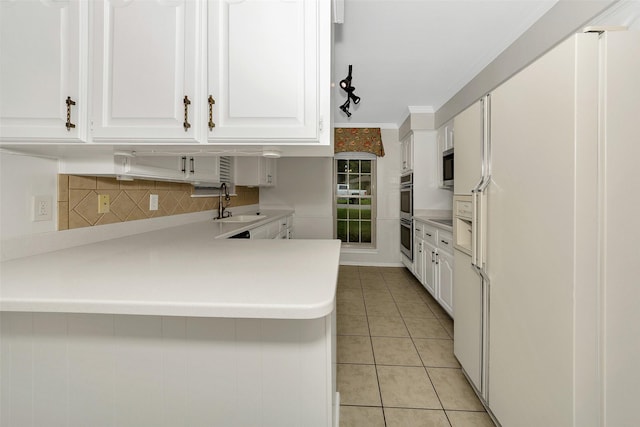 1631 Idlewood Dr, Sherman, TX 75092 - kitchen with appliances with stainless steel finishes, white cabinetry, tasteful backsplash, light tile patterned floors, and light countertops