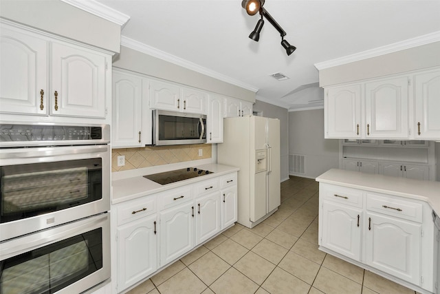1631 Idlewood Dr, Sherman, TX 75092 - kitchen featuring stainless steel appliances, light tile patterned floors, tasteful backsplash, light countertops, and white cabinetry