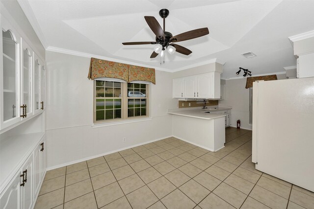 1631 Idlewood Dr, Sherman, TX 75092 - kitchen with freestanding refrigerator, white cabinetry, light countertops, a ceiling fan, and light tile patterned flooring