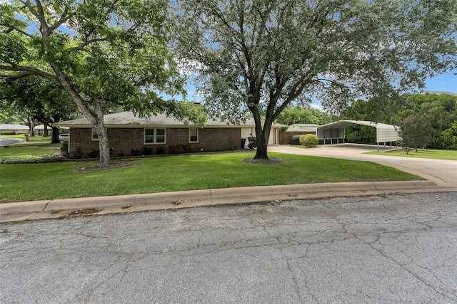 1631 Idlewood Dr, Sherman, TX 75092 - view of front of property with concrete driveway, a detached carport, a front yard, and brick siding