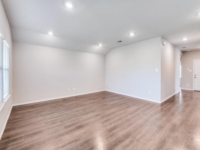 410 Wrangler Dr, Josephine, TX 75189 - empty room with wood finished floors, recessed lighting, baseboards, and vaulted ceiling