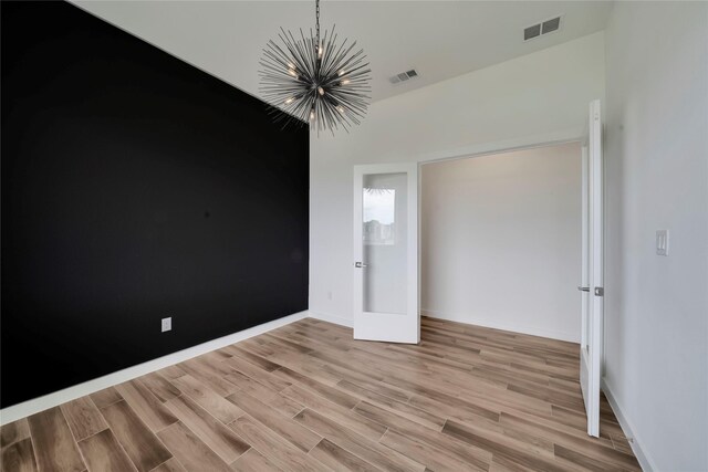 8356 Fairview Dr, Frisco, TX 75033 - unfurnished bedroom featuring a chandelier, light wood-style flooring, and baseboards