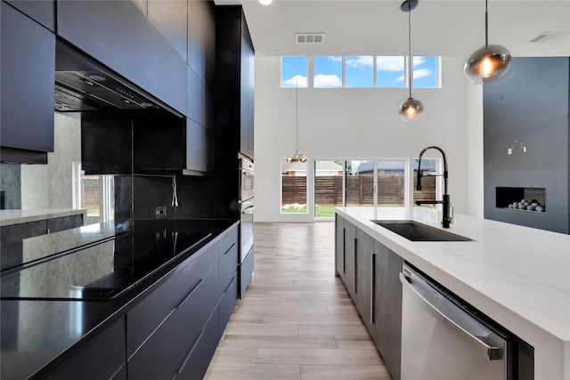 8356 Fairview Dr, Frisco, TX 75033 - kitchen with stainless steel appliances, a sink, modern cabinets, a high ceiling, and pendant lighting