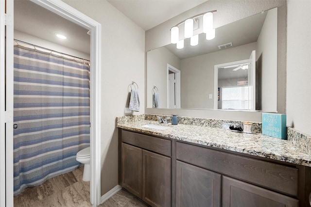 10517 Arabella Ln, Waco, TX 76708 - bathroom featuring vanity, toilet, and ceiling fan