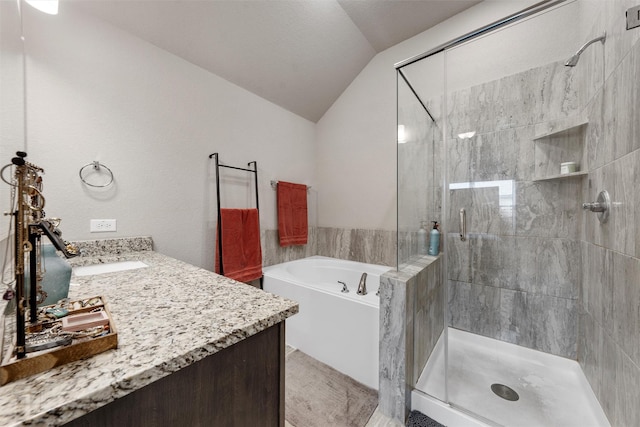 10517 Arabella Ln, Waco, TX 76708 - bathroom featuring lofted ceiling, a bath, a stall shower, and vanity