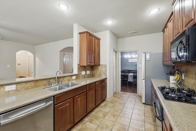 3425 Furlong Way, Fort Worth, TX 76244 - kitchen featuring black appliances, arched walkways, backsplash, light tile patterned floors, and recessed lighting
