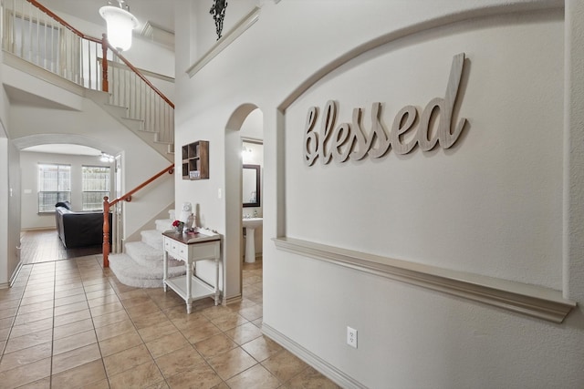 3425 Furlong Way, Fort Worth, TX 76244 - hall featuring arched walkways, stairway, light tile patterned floors, and a high ceiling