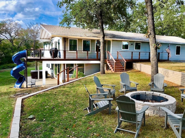 311 Oak Ln, Tool, TX 75143 - rear view of property featuring an outdoor fire pit, stairs, a lawn, and a wooden deck