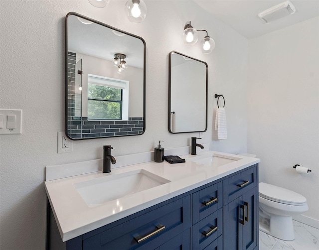 311 Oak Ln, Tool, TX 75143 - bathroom with double vanity, marble look tile flooring, and toilet