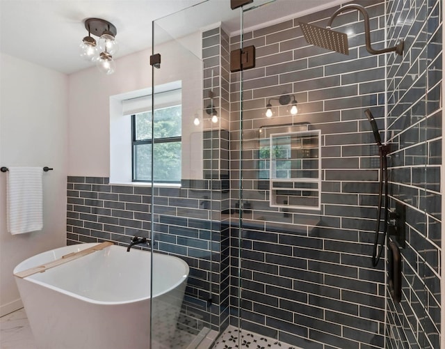 311 Oak Ln, Tool, TX 75143 - full bathroom featuring a freestanding bath, a stall shower, marble look tile flooring, and tile walls