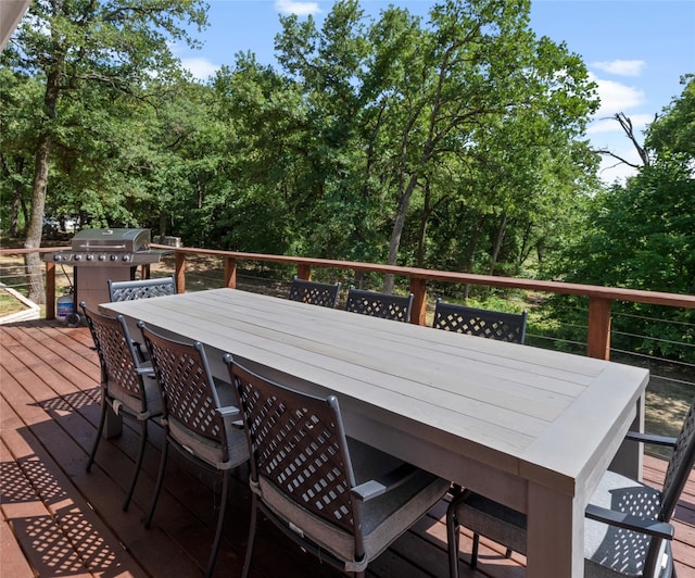 311 Oak Ln, Tool, TX 75143 - deck with outdoor dining space and view of scattered trees