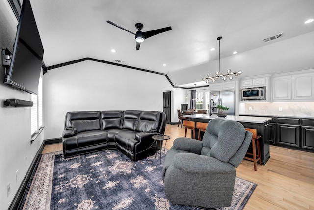 2600 Lakeview Ct, Prosper, TX 75078 - living area with vaulted ceiling, ceiling fan, recessed lighting, light wood finished floors, and ornamental molding