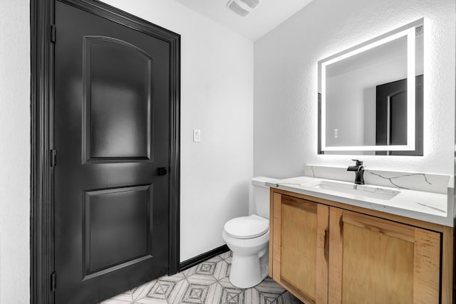 2600 Lakeview Ct, Prosper, TX 75078 - bathroom featuring vanity, toilet, tile patterned floors, and baseboards