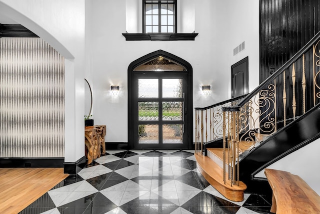 2600 Lakeview Ct, Prosper, TX 75078 - entrance foyer featuring a high ceiling, stairs, arched walkways, baseboards, and tile patterned floors