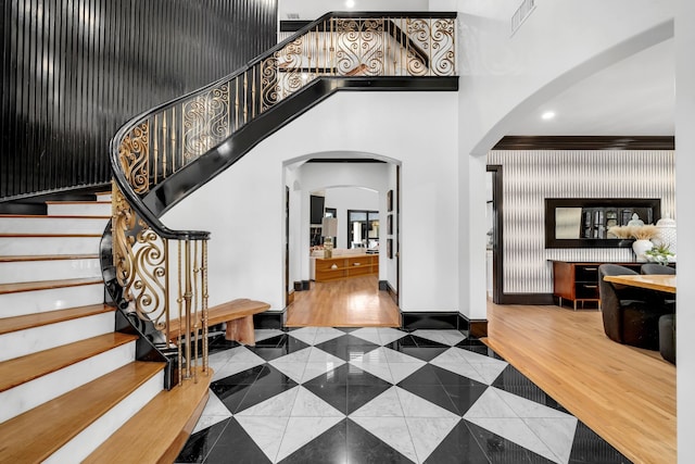 2600 Lakeview Ct, Prosper, TX 75078 - tiled entryway featuring arched walkways, a high ceiling, stairway, ornamental molding, and recessed lighting