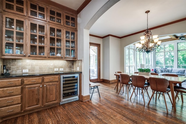 3704 Imperial Dr, Flower Mound, TX 75028 - indoor dry bar with beverage cooler, arched walkways, dark wood-style floors, decorative backsplash, and baseboards