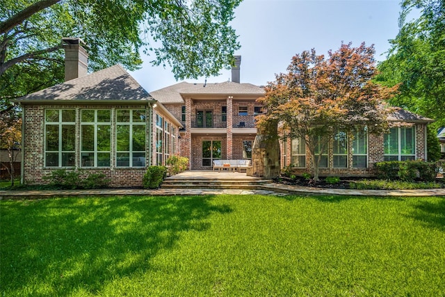 3704 Imperial Dr, Flower Mound, TX 75028 - rear view of property with a chimney, brick siding, a lawn, and a patio area